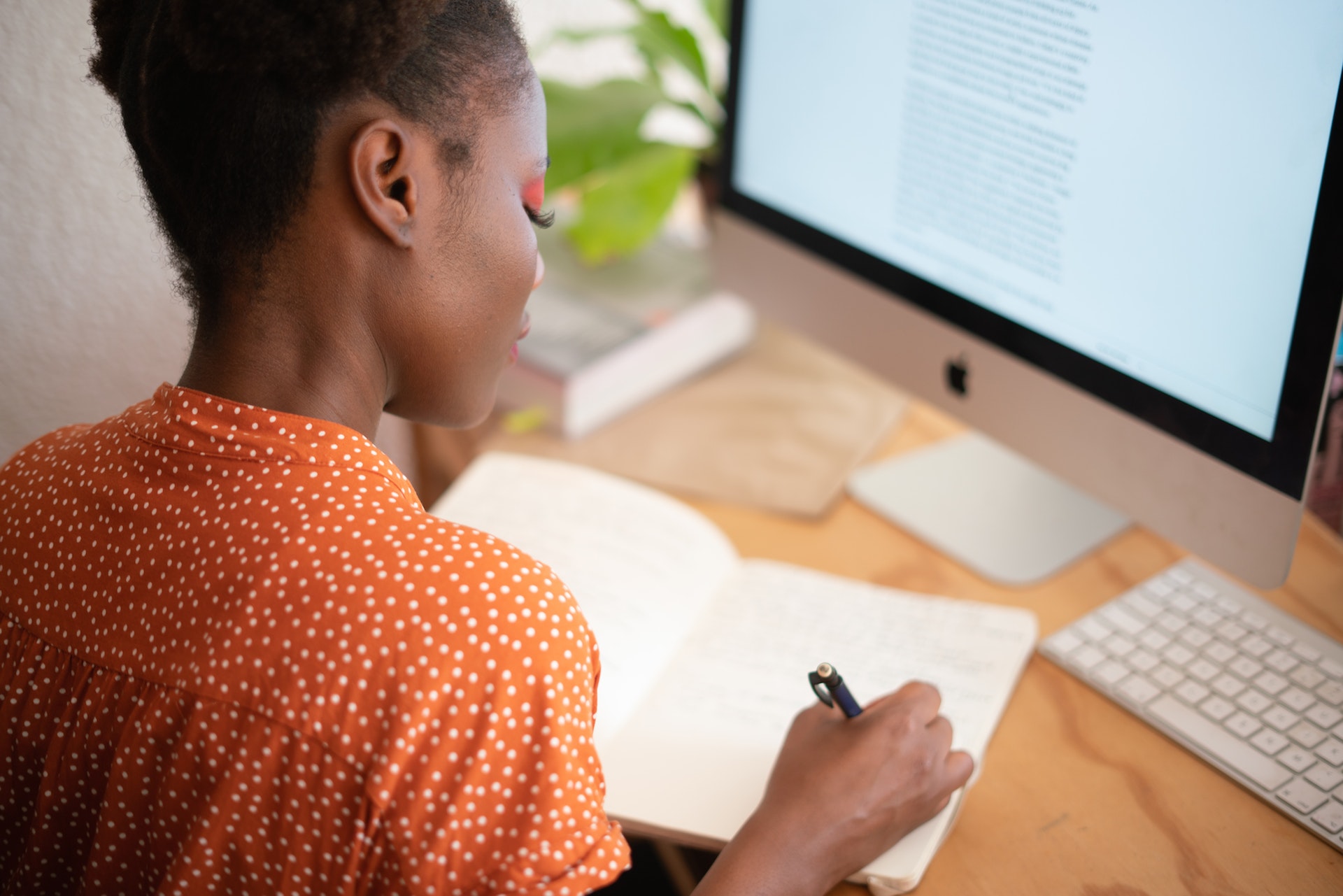 woman-writing-on-her-notebook-3059747 2